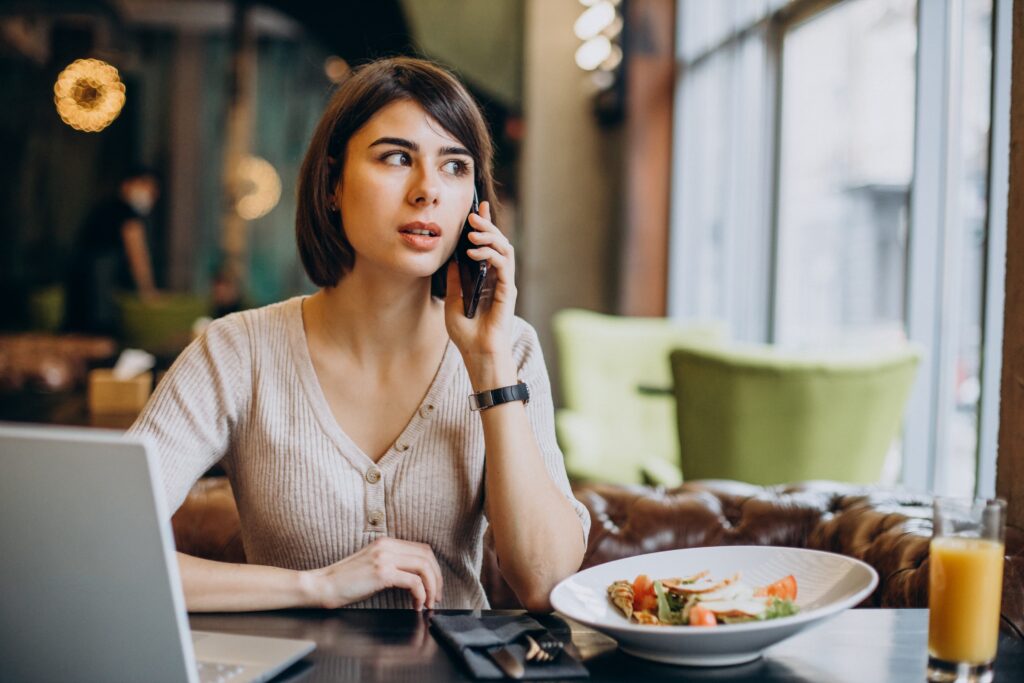 young-woman-having-lunch-cafe-working-laptop (1)